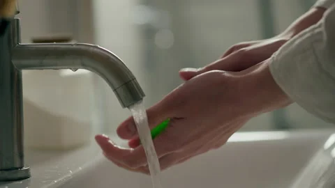 In an effort to keep herself healthy, a young woman diligently washes her ha Stock Footage 234739103