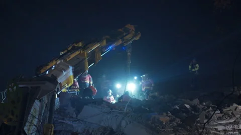 Efforts are being made to rescue people trapped under the rubble. Stock Footage 233220931
