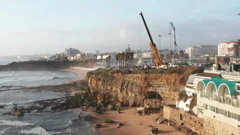 Efforts to Stop Soil Erosion on the Beach in Sao Pedro Do Estoril aerial view Stock Footage 344746423