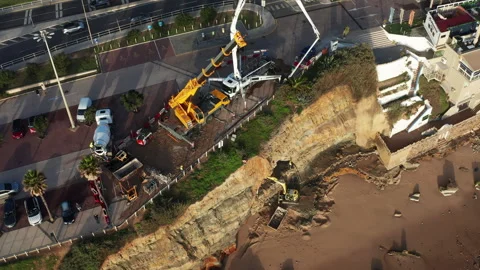 Efforts to Stop Soil Erosion at Sao Pedro Beach Using Equipment and Workers Stock Footage 344746346
