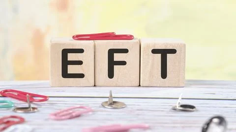 EFT text written on wooden cubes on a light colored background Stock Illustration