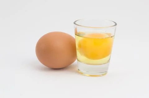 Egg and broken egg in a cup Stock Photos