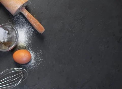 Egg and flour on dark background top view Stock Photos