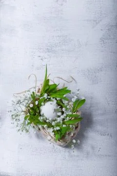Egg and flowers on a white surface. Easter symbols Stock Photos
