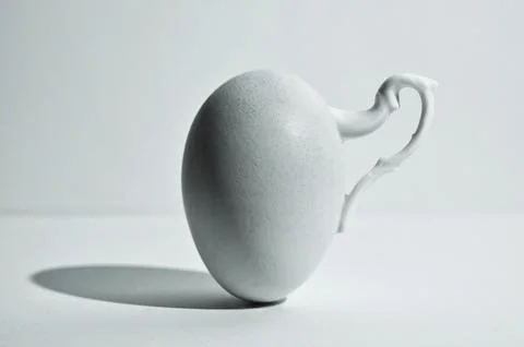 Egg and Shadow With Handle Of A  Cup Photos