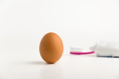 Egg and toothpaste Stock Photos
