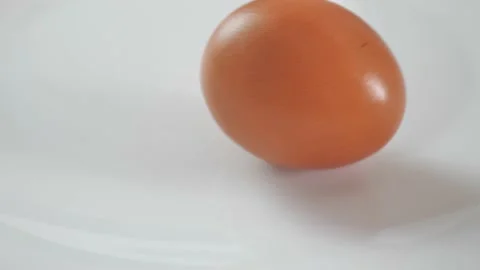 Egg are rolling on the white table. Easter eggs background. Can be used as Stock Footage 209158294