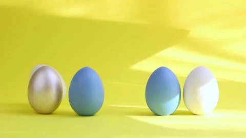 Egg are rolling on the yelloy background, knock each other. Easter colorful eggs Stock Footage 234201471
