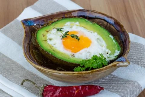 Egg backed in avocado Stock Photos