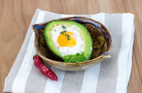 Egg backed in avocado Stock Photos