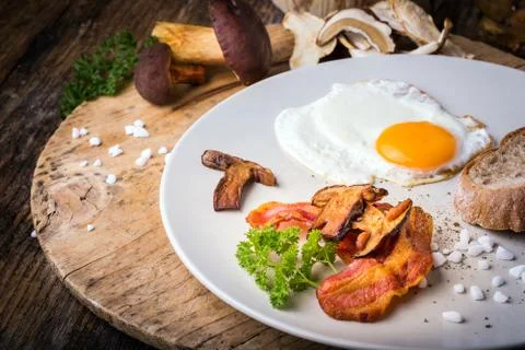 Egg with bacon and mushrooms Stock Photos