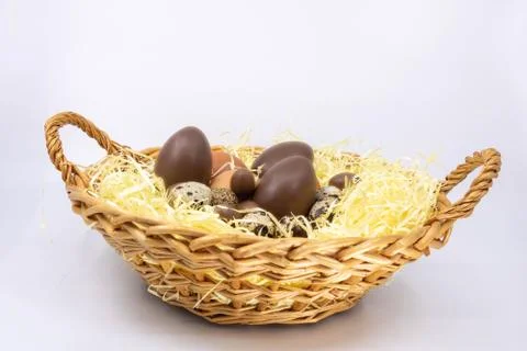 Egg basket for Easter, chicken egg, quail egg and chocolate egg Stock Photos