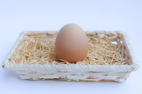 Egg in basket wicker Stock Photos