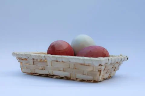Egg in basket wicker Stock Photos