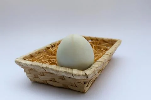 Egg in basket wicker Stock Photos