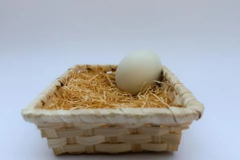 Egg in basket wicker Stock Photos