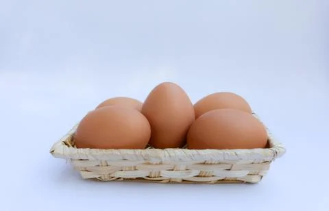 Egg in basket wicker Stock Photos