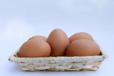 Egg in basket wicker Stock Photos
