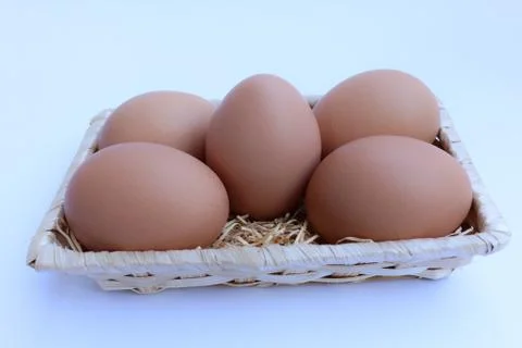 Egg in basket wicker Stock Photos