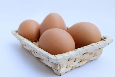 Egg in basket wicker Stock Photos