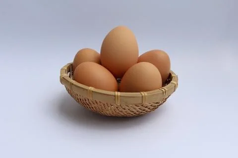 Egg in basket wicker Stock Photos