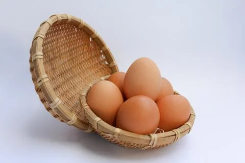 Egg in basket wicker Stock Photos