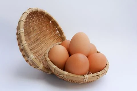 Egg in basket wicker Stock Photos