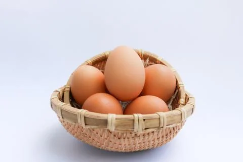 Egg in basket wicker Stock Photos