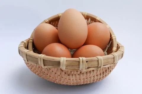 Egg in basket wicker Stock-Fotos