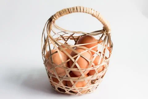 Egg in basket wicker on white background,Duck eggs in baskets . Foto stock
