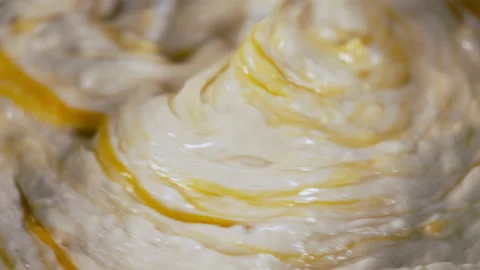 Egg beater in a mixture of flour and raw eggs in baking concept Stock Footage 162483946