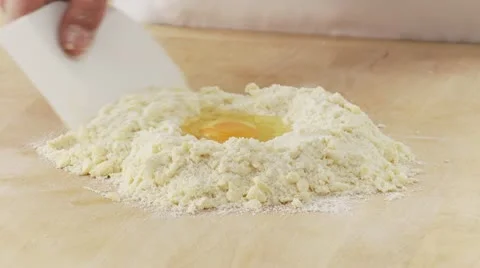 An egg being added to a butter-flour mixture 스톡 동영상 24641860