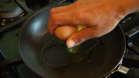 Egg Being Cracked and fried in Hot Oil Stock Footage 24703064
