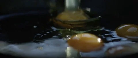 Egg being cracked into frying pan Stock Footage 69199683