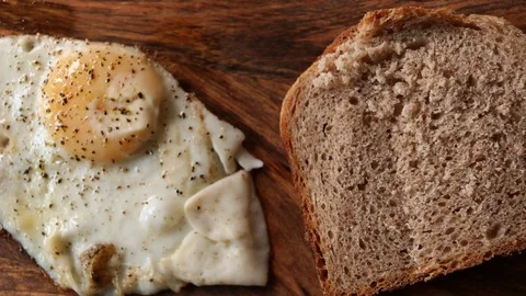 Egg being fried and served with bread. Stop motion animation. Stock Footage 88939220
