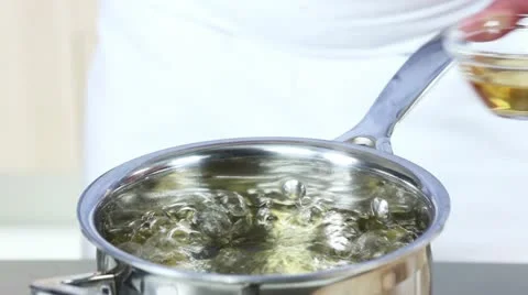 An egg being poached in vinegar water Stock Footage 24671595
