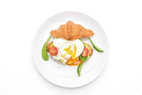 Egg benedict with avocado, tomatoes and salad - healthy or vegan food style Stock Photos