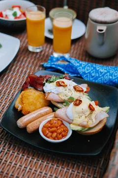 Egg benedict on black plate Stock Photos