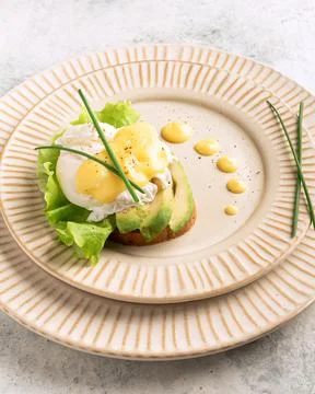 Egg benedict on a plate, plating, close-up Stock Photos