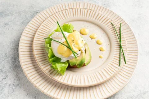 Egg benedict on a plate, plating, close-up Foto stock