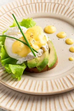 Egg benedict on a plate, plating, close-up Stock Photos