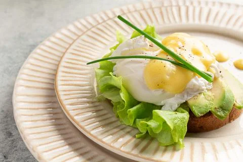 Egg benedict on a plate, plating, close-up Stock Photos