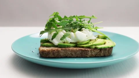 Egg benedict with poached egg with crispy hot grilled toast,hands spread ar.. Stock Footage 252381347