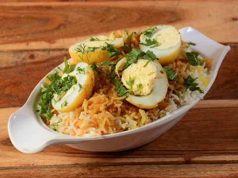Egg Biryani - Basmati rice cooked with masala and spices and served with slic Stock Photos