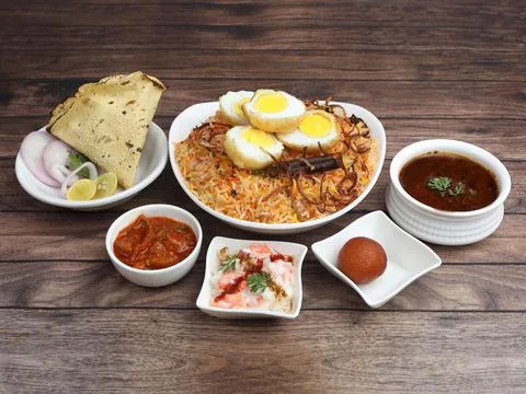Egg Biryani Thali - Basmati rice cooked with masala roasted eggs and spices a Stock Photos