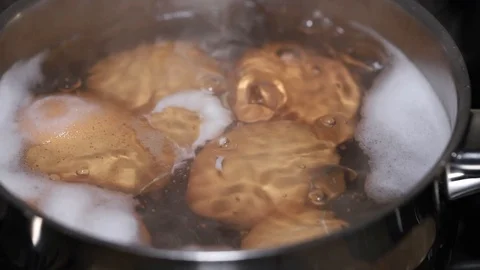 Egg boiling in water in iron pot Video stock 123693446