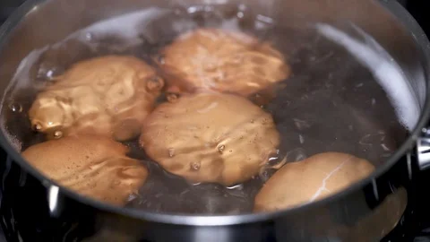Egg boiling in water in iron pot Video stock 123693569