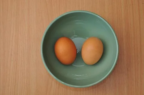 Egg on bowl Stock Photos