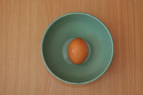 Egg on bowl Stock Photos