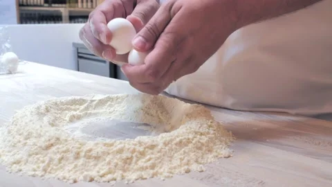 Egg breaking chef prepares pasta dough Stock-Footage 131310448